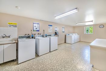 A laundry room with washers and dryers.